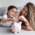 Happy mother and son saving money in a piggybank