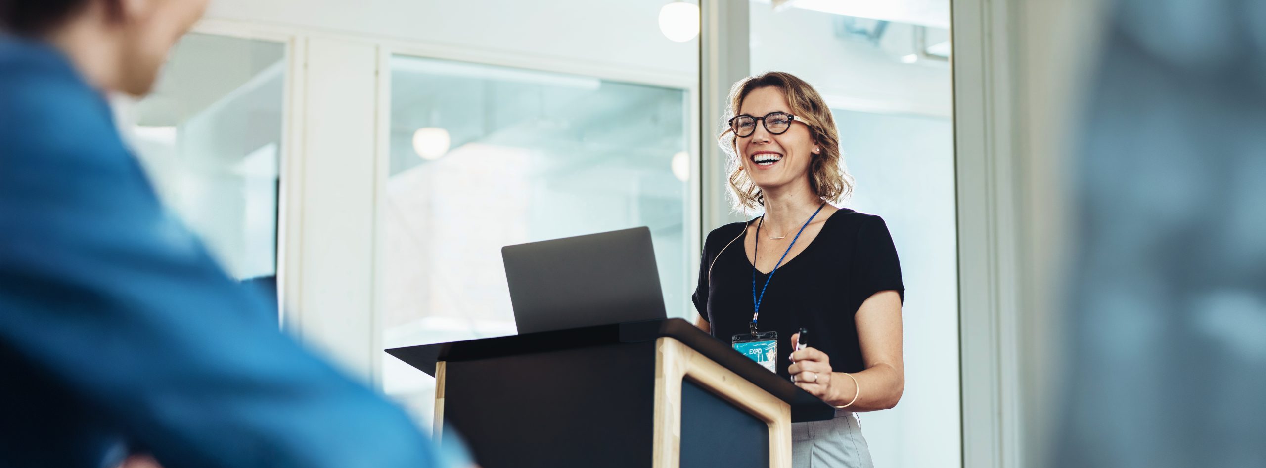 Confident woman leading presentation at business event