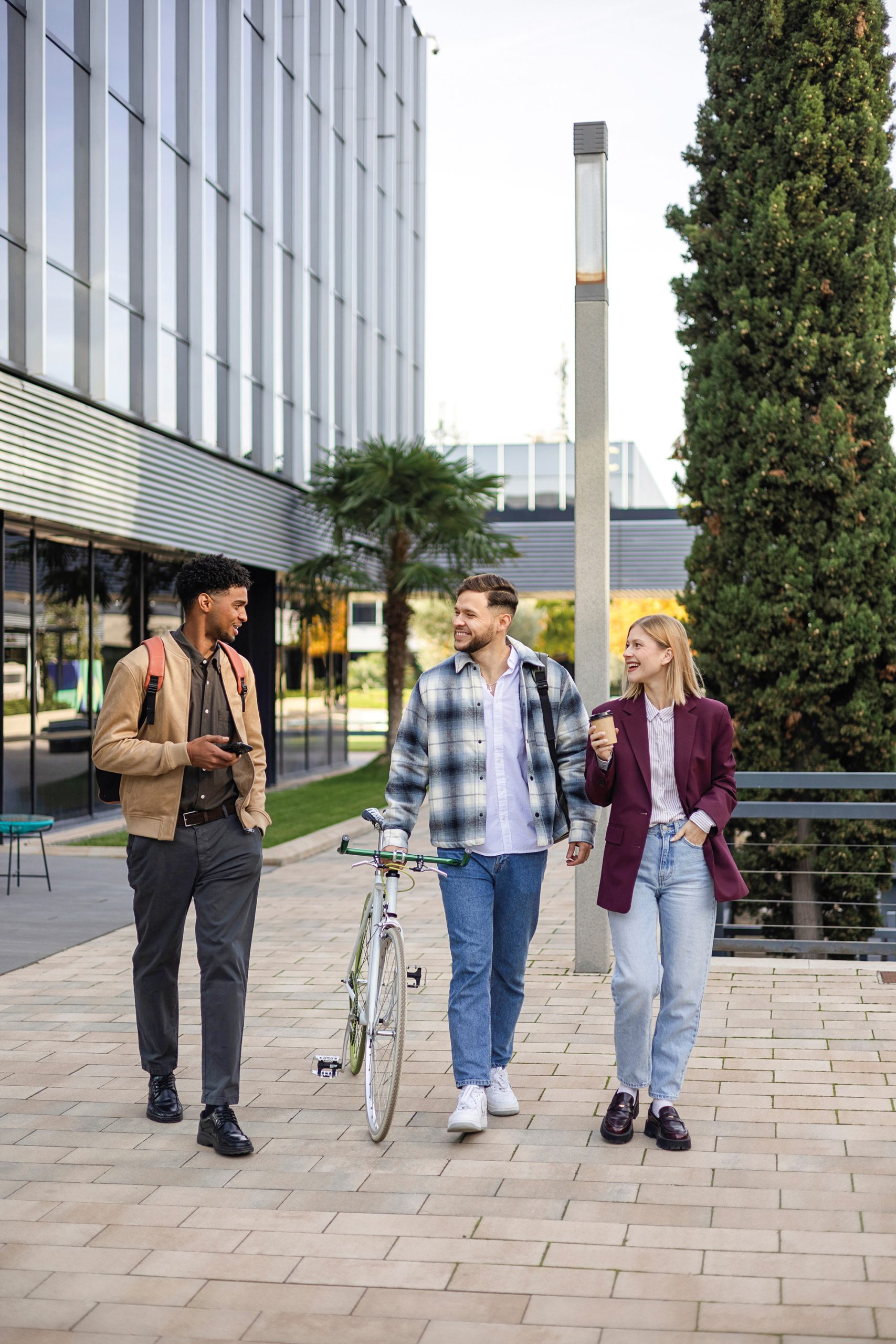 Diverse students walking on campus talking and smiling