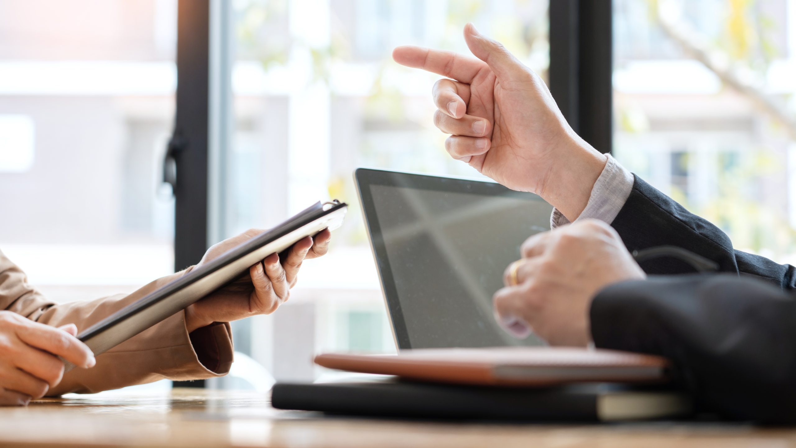 businessman candidate explaining about his profile and conducting a job to managers sitting in job Interview in modern office, consulting or employment concept.